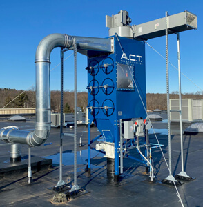 Five Dust Collectors On The Roof of A Large Manufacturing Plant