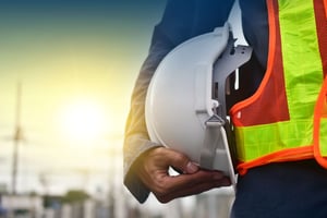 technician holding a safety hard hat